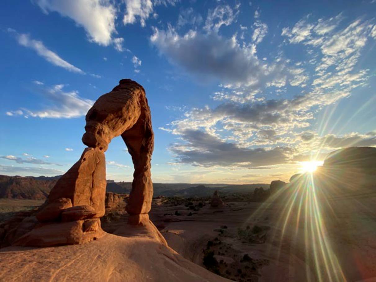 A photo of a beautiful sunset and the desert with rock outcroppings